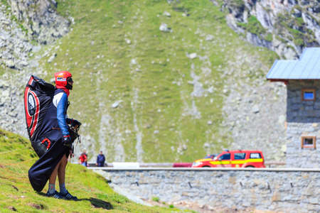Balea Lake, Romania - JULY 21, 2014: Unidentified paraglider in Balea Lake, Fagaras Mountain, Romania. Paragliding is one of the most popular adventure sports in the world のeditorial素材