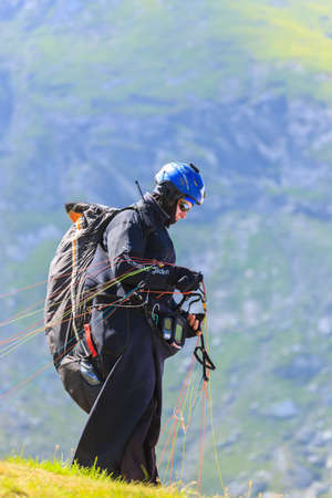 Balea Lake, Romania - JULY 21, 2014: Unidentified paraglider in Balea Lake, Fagaras Mountain, Romania. Paragliding is one of the most popular adventure sports in the worldのeditorial素材