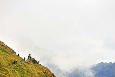 Zakopane, POLAND - September 13: Group of tourists walk to the top of the Kasprowy Wierch in Tatra Mountains on September 13, 2014 in Tatra Mountains, Poland.のeditorial素材