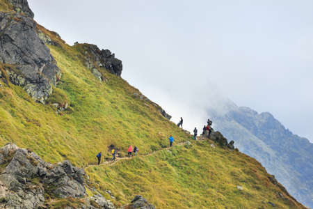 Zakopane, POLAND - September 13: Group of tourists walk to the top of the Kasprowy Wierch in Tatra Mountains on September 13, 2014 in Tatra Mountains, Poland.のeditorial素材