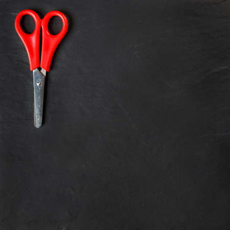 red scissors on black backgroundの写真素材