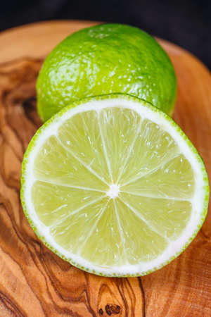green lemons on the wooden table
