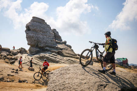 Bucegi Mountains, Romania July 09, 2015: Unidentified group of bikers climbs the hill in Bucegi Mountains in Romania on July 09, 2015.のeditorial素材