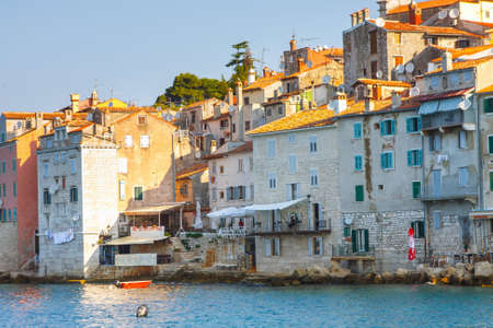 Rovinj, Croatia, 12 JULY 2012: Morning view on old town Rovinj from harbor with outdoor restaurants, Croatiaのeditorial素材
