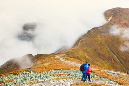 Tatra Mountains, Poland - October 10: Tourists walking in a foggy day to the top of the Kasprowy...