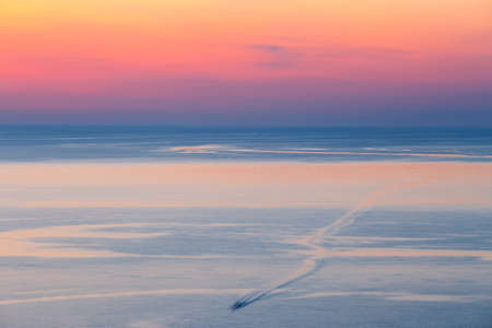 sunset over the mountain with reflection on the seaの写真素材