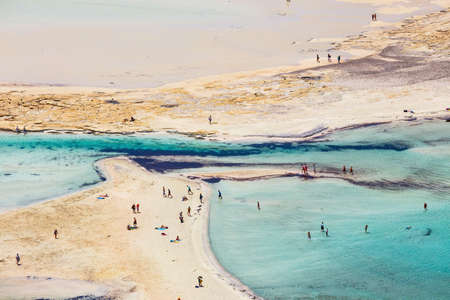 Crete, Greece -Unidentified people sunbathing and strolling along the beach in Balos Lagoon on Crete, Greeceの写真素材