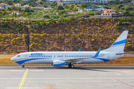 Funchal, Madeira - July 6, 2016: Enter Air Boeing 737 lands at Funchal Cristiano Ronaldo Airport. This airport is one of the most dangerous airports in Europeのeditorial素材