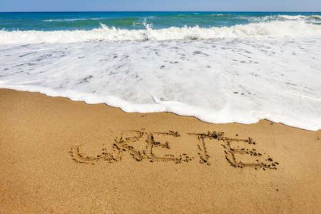 Crete inscription on the sand near the seaの写真素材