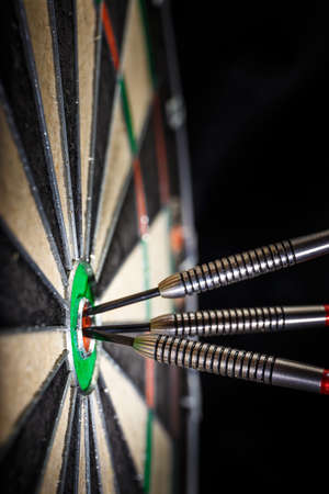 three darts in bull's eye, close upの写真素材