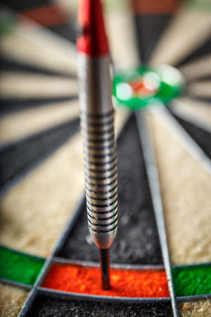 the darts hitting perfect 180 score on dart board, close up