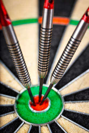 three darts in bull's eye, close upの写真素材