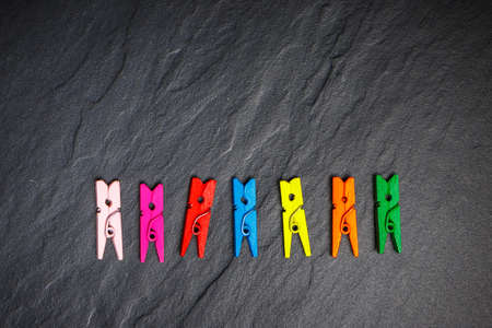 colorful clothes pegs on black board, top viewの写真素材