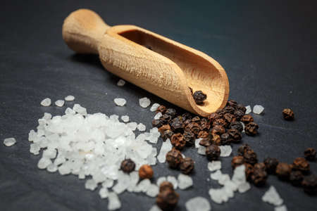 black pepper and salt on rustic stone background. Overhead view food photographyの写真素材