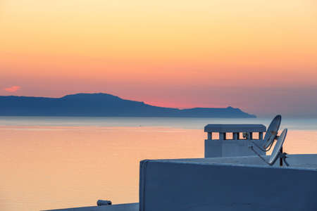 sunset over the mountain with reflection on the seaの写真素材
