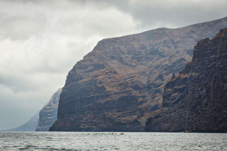 view of the cloudy cliffs of Los Gigantes in Tenerife, Canary Islands, Spainの写真素材