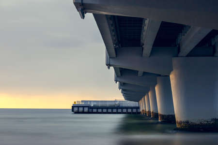 Concrete pier in Kolobrzeg, long exposure shot at sunsetの写真素材