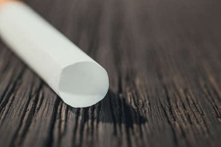 cigarette tube left on the brown wooden table, close up with copy spaceの写真素材