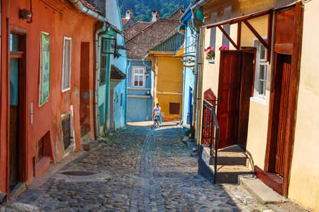 SIGHISOARA, ROMANIA - JULY 08, 2015: Unidentified tourists walking in historic town Sighisoara. City in which was born Vlad Tepes, Draculaのeditorial素材