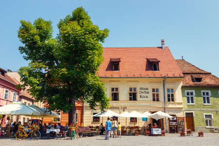 SIGHISOARA, ROMANIA - JULY 08, 2015: Unidentified tourists walking in historic town Sighisoara. City in which was born Vlad Tepes, Draculaのeditorial素材