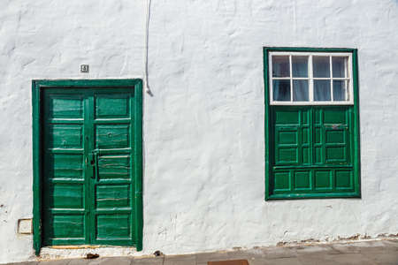 green door and window on white wall background