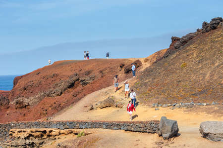 LANZAROTE, SPAIN - March 30, 2017: Unidentified people walking  in El Golfo and Green Lagoon. The Gulf is a lagoon in a volcanic crater surrounded by steep cliffs.のeditorial素材