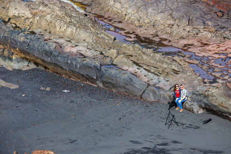 LANZAROTE, SPAIN - March 30, 2017: Unidentified people walking  in El Golfo and Green Lagoon. The Gulf is a lagoon in a volcanic crater surrounded by steep cliffs.のeditorial素材