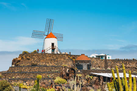 LANZAROTE - March 29, 2017: View of cactus garden with white windmill in Guatiza, popular attraction in Lanzarote, Canary islandsのeditorial素材