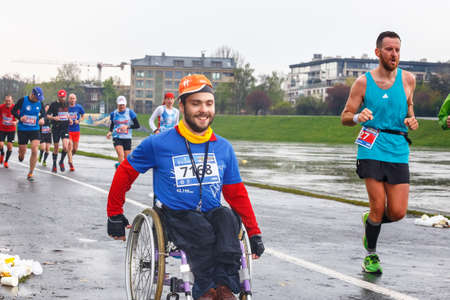 KRAKOW, POLAND - April 30, 2017: Unidentified handicapped man in marathon on a wheelchair on the city streets during  16 Cracovia marathon . The marathon is an annual event.のeditorial素材