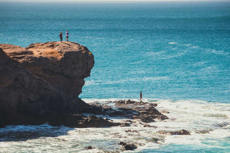 volcanic coastline with wavy ocean and blue sky, Lanzarote island, Spainの写真素材
