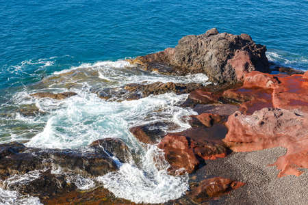 volcanic coastline with wavy ocean and blue sky, Lanzarote island, Spainの写真素材