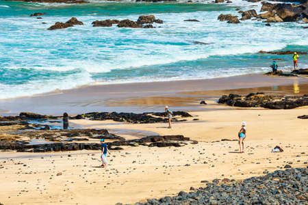 El Cotillo, Fuerteventura, Spain, April 03, 2017: Unknown people on a beach in El Cotillo village in...