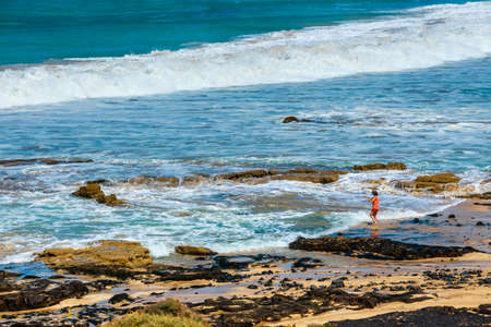El Cotillo, Fuerteventura, Spain, April 03, 2017: Unknown people on a beach in El Cotillo village in Fuerteventura island, Spainのeditorial素材