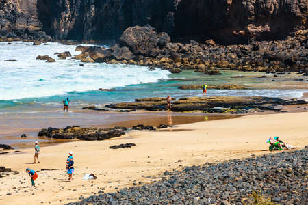 El Cotillo, Fuerteventura, Spain, April 03, 2017: Unknown people on a beach in El Cotillo village in Fuerteventura island, Spainのeditorial素材