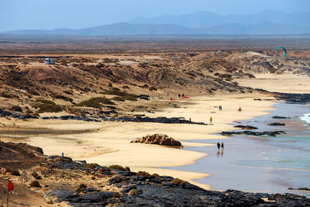 El Cotillo, Fuerteventura, Spain, April 03, 2017: Unknown people on a beach in El Cotillo village in Fuerteventura island, Spainのeditorial素材