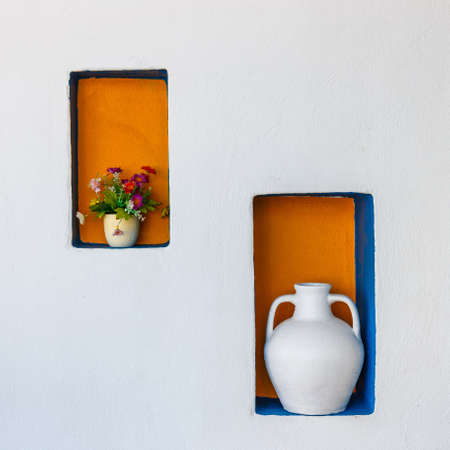 Greek style ceramic white vase on white wall backgroundの写真素材