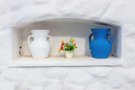 Greek style ceramic white and blue vases on white wall backgroundの写真素材