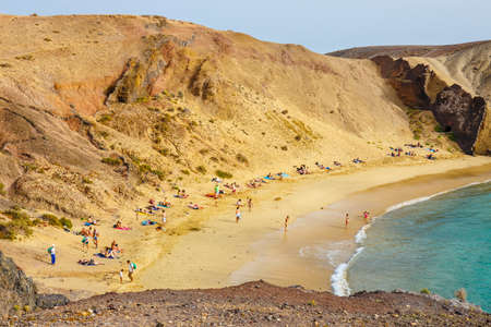 Lanzarote, Playa Blanca, March 31, 2017:Group of people relaxing on Papagayo beach on the island of Lanzarote, Spainのeditorial素材