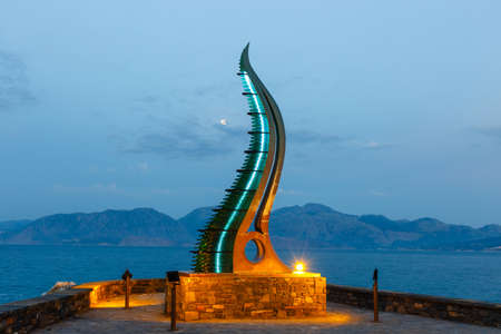 Keras Amaltheias monument in Agios Nikolaos town at summer evening, Crete Island, greeceのeditorial素材