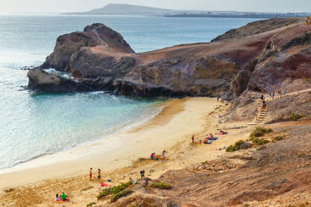 Lanzarote, Playa Blanca, March 31, 2017:Group of people relaxing on Papagayo beach on the island of Lanzarote, Spainのeditorial素材
