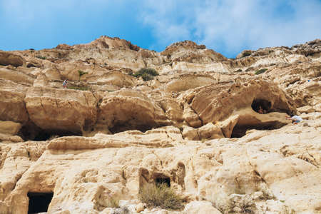 Crete Island, Greece, June 09, 2017: Panorama of Matala beach. Caves on the rocks were used as a roman cemetery and at the decade of 70's were living hippies from all over the world, Crete, Greeceのeditorial素材