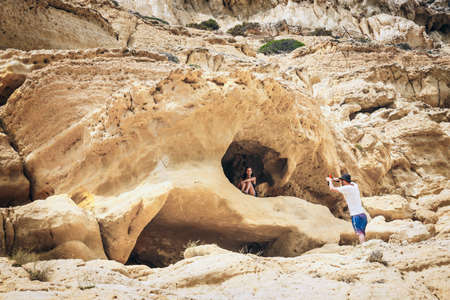 Crete Island, Greece, June 09, 2017: Panorama of Matala beach. Caves on the rocks were used as a roman cemetery and at the decade of 70's were living hippies from all over the world, Crete, Greeceの写真素材