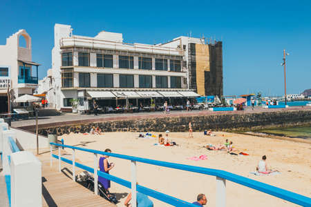 Corralejo, Furteventura, Spain - April 03, 2017: View of public beach in Corralejo with the port in the backgroundのeditorial素材