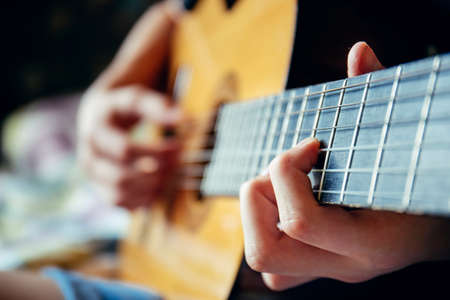 musician playing acoustic guitar, live music background