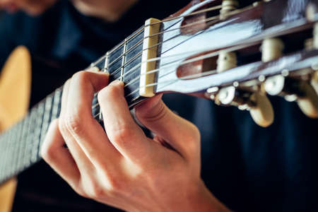 musician playing acoustic guitar, live music background