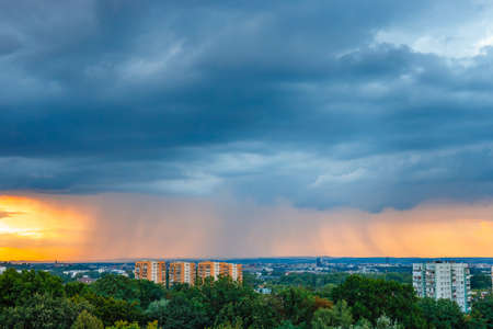 A huge storm cloud with a wall of rain over the city