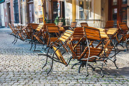 tables and chairs in the outdoor restaurant in the old town in Pragueの写真素材