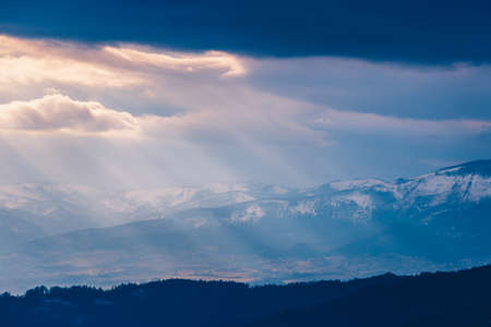 Rays of light pass through the clouds, mountain landscapeの写真素材