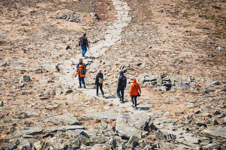 unidentified hikers travel in the Babia Gora Mountain with a backpackesの写真素材