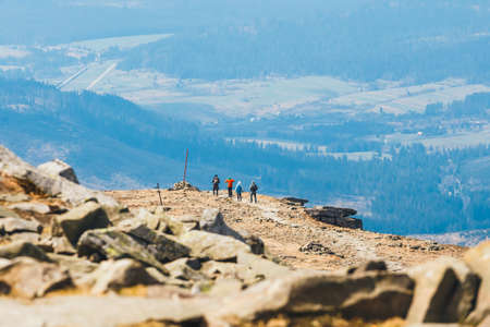 unidentified hikers travel in the Babia Gora Mountain with a backpackesの写真素材